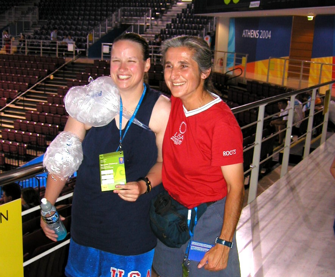 Dawn standing with female USA athlete in arena at 2004 Olympics in Athens, Greece