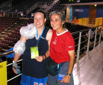 Dawn standing with female USA athlete in arena at 2004 Olympics in Athens, Greece